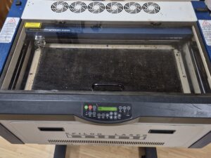 Epilog Mini laser engraver with the lid closed and control panel visible Epilog Mini laser engraver with the lid closed and control panel visible