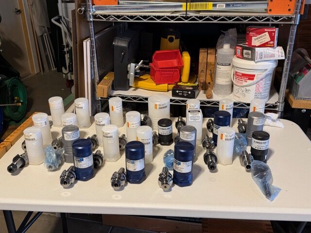 Additional CNC tool holders and packaged tooling arranged for inspection