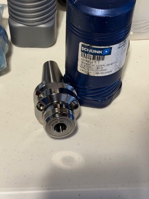SCHUNK tool holder beside its labeled protective container