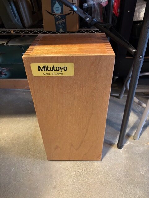Closed wooden storage case with Mitutoyo manufacturer badge