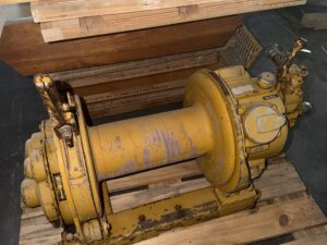 Side view of the Ingersoll Rand air winch on a pallet with bare drum